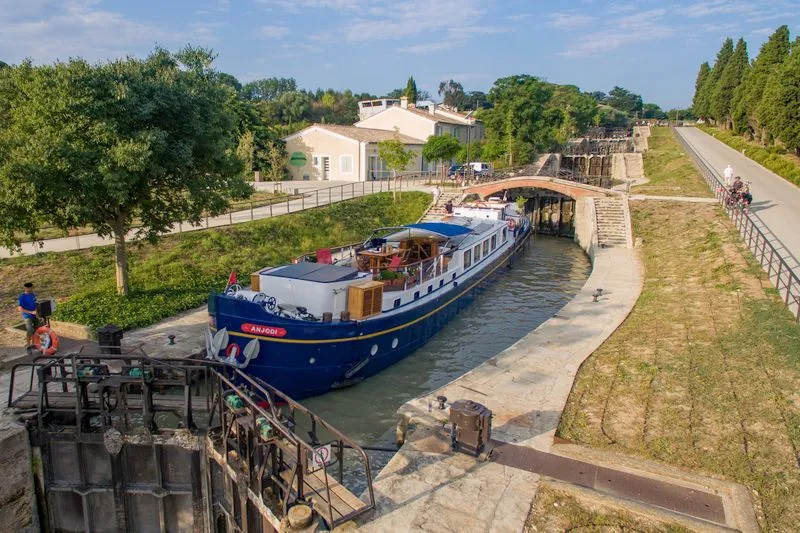 The Fonserannes staircase of locks on the Canal du Midi, water held by stepped gates and released only in sequence.